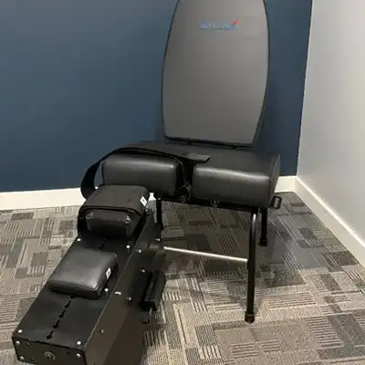 Knee decompression therapy table and treatment equipment in a chiropractic clinic, designed to help reduce knee pain and improve joint function.