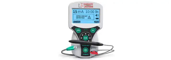 Close-up of a Stimpod NMS 460 neuromodulation device displayed with treatment probe and connection cables.